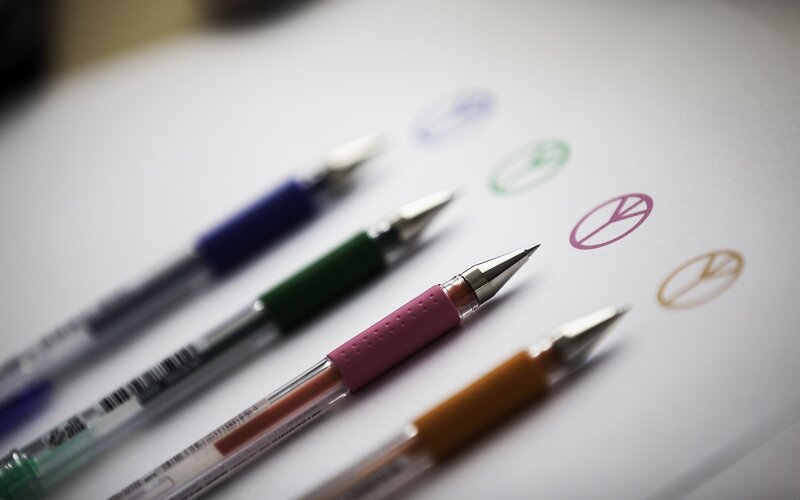 Colorful pens with peace symbols