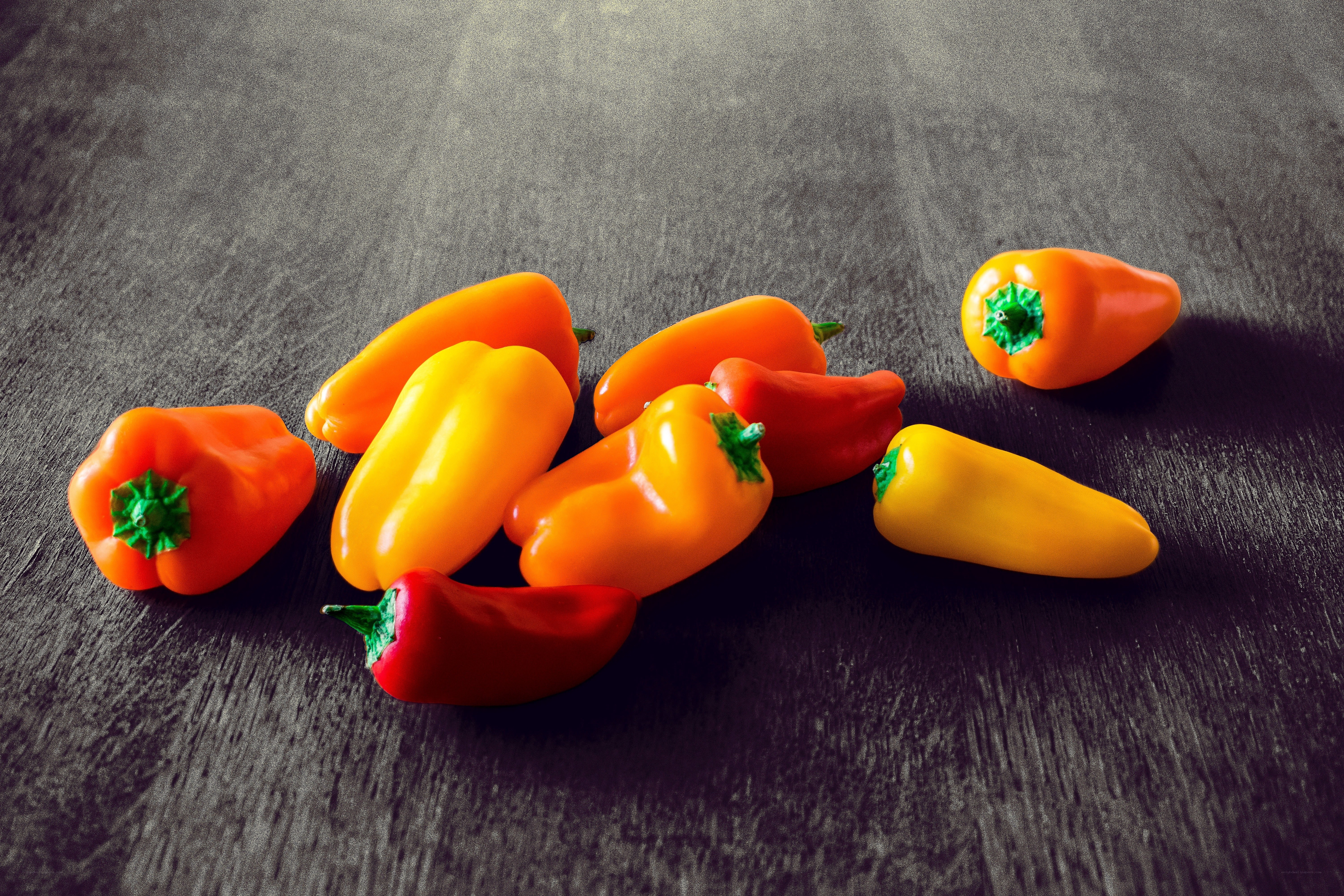 Colorful peppers on dark wood