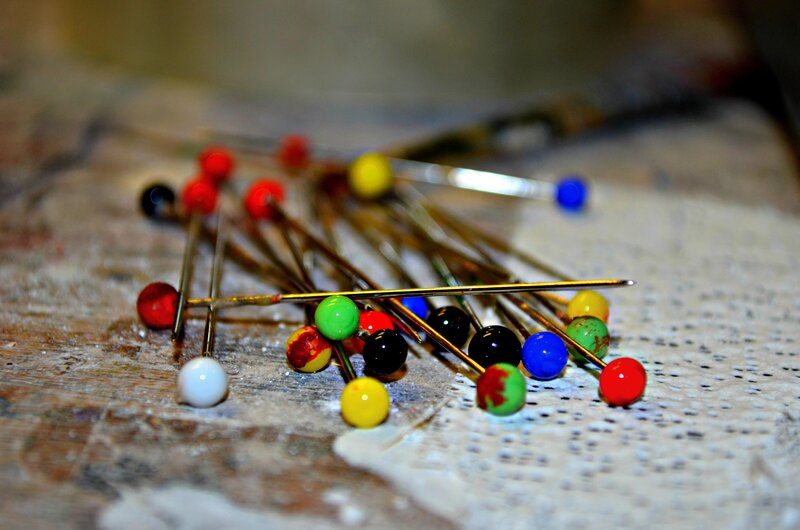 Colorful pins on a wooden surface