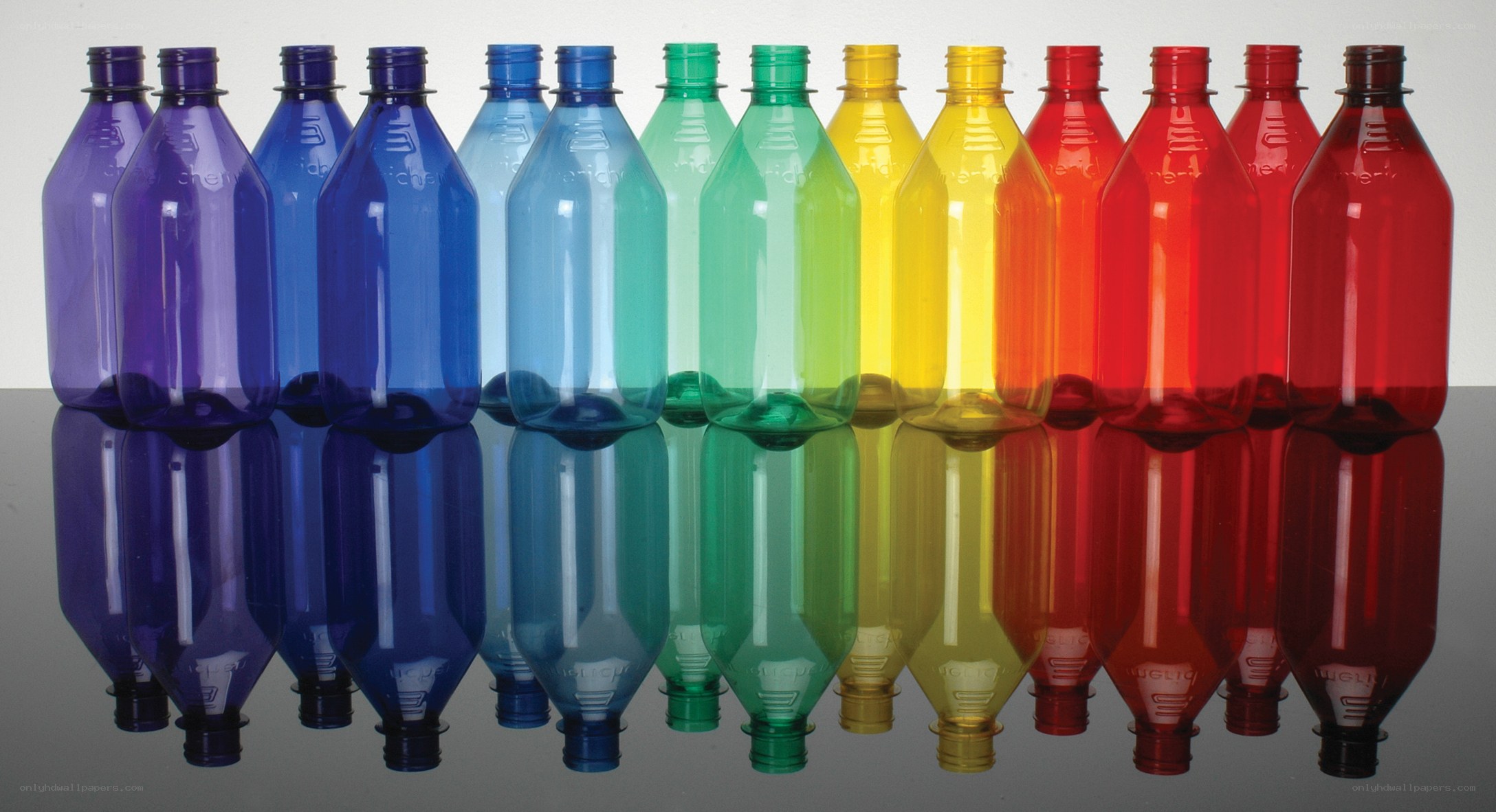 Colorful plastic bottles in rainbow order