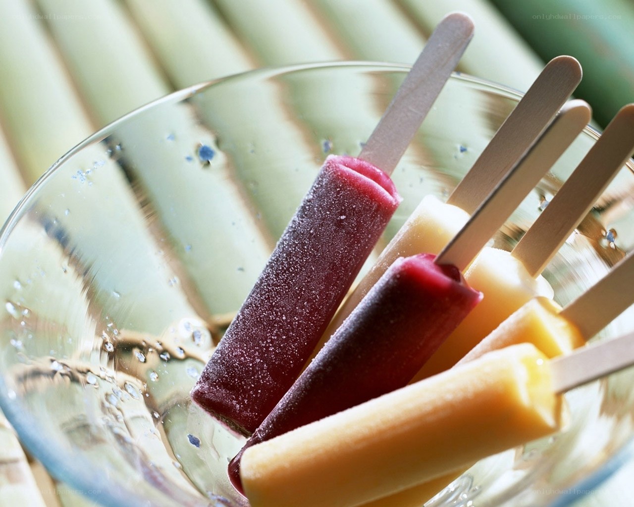 Colorful popsicles in a glass bowl