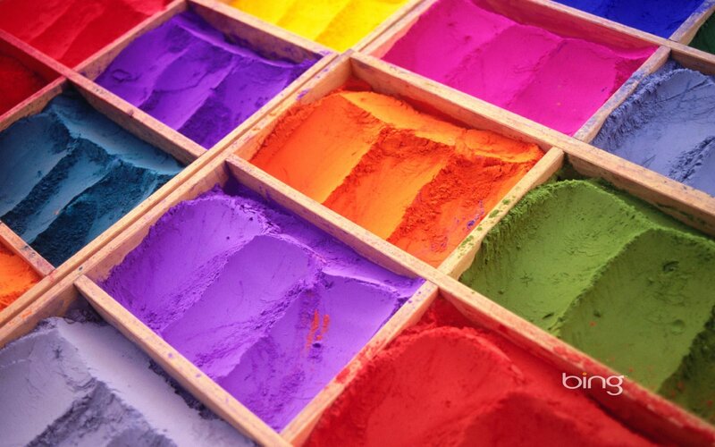 Colorful powder in wooden boxes