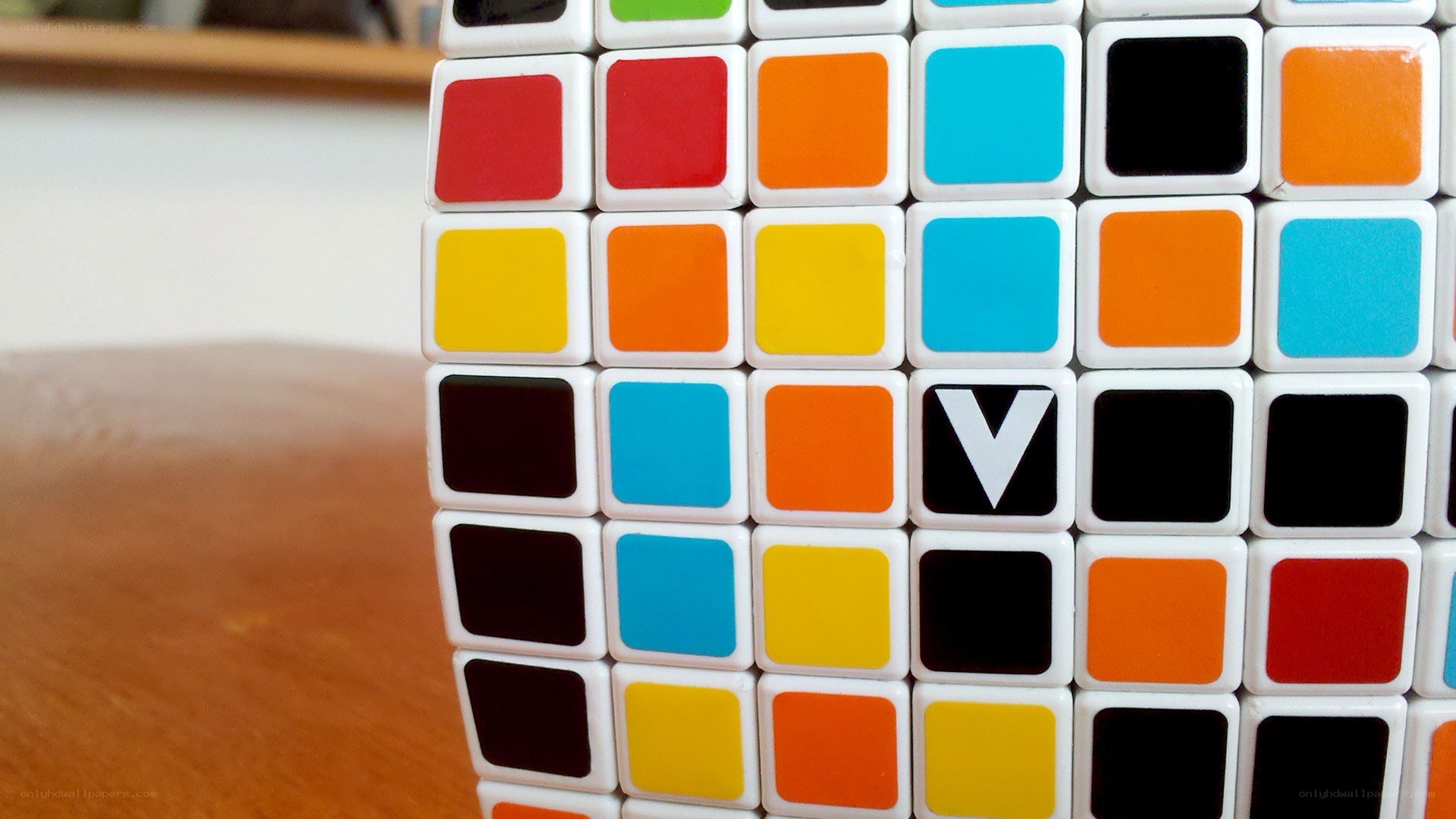 Colorful puzzle cube with V logo