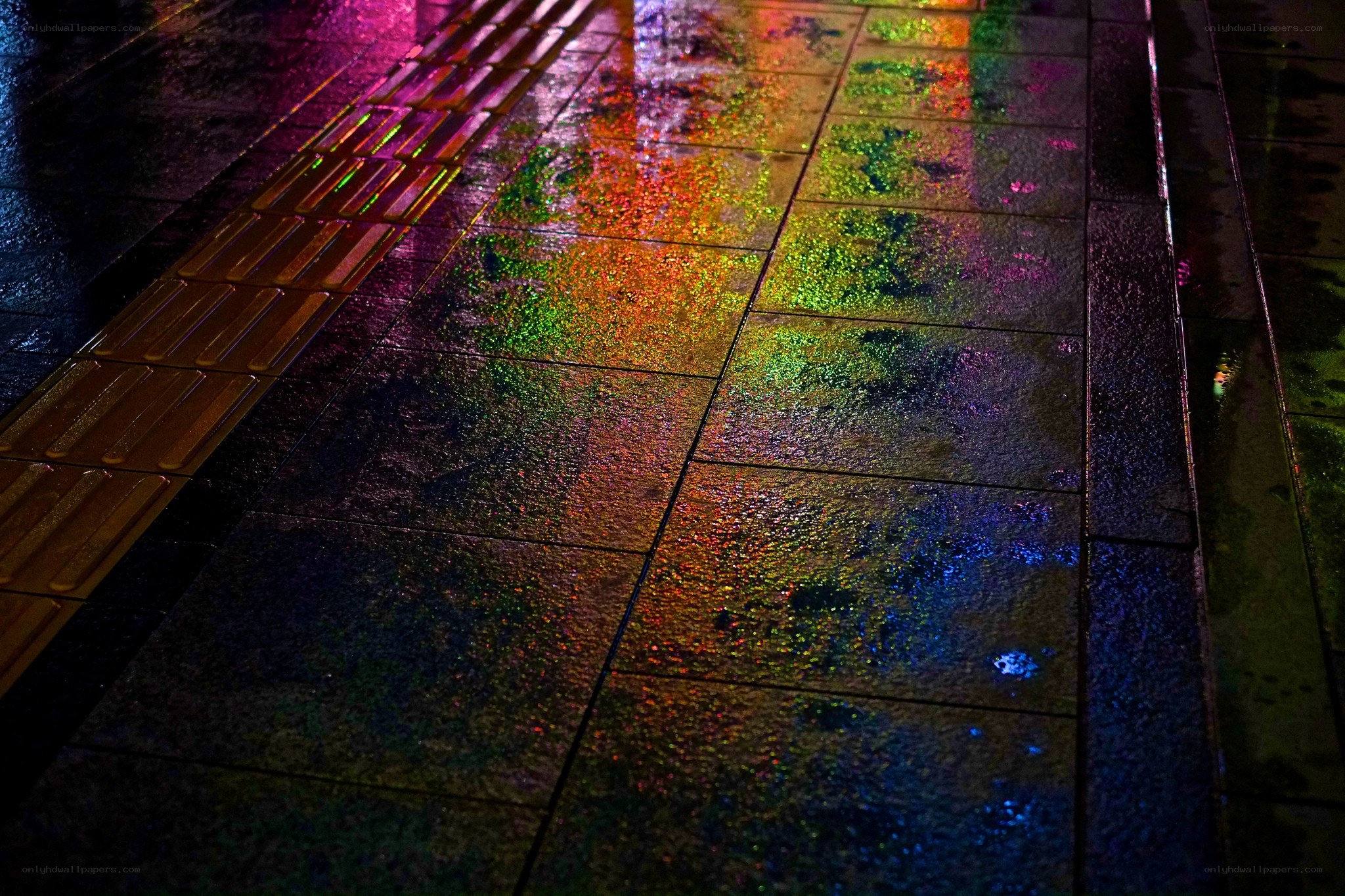 colorful reflections on wet pavement