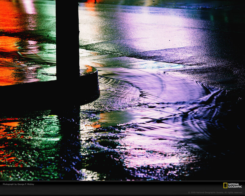 Colorful reflections on wet pavement