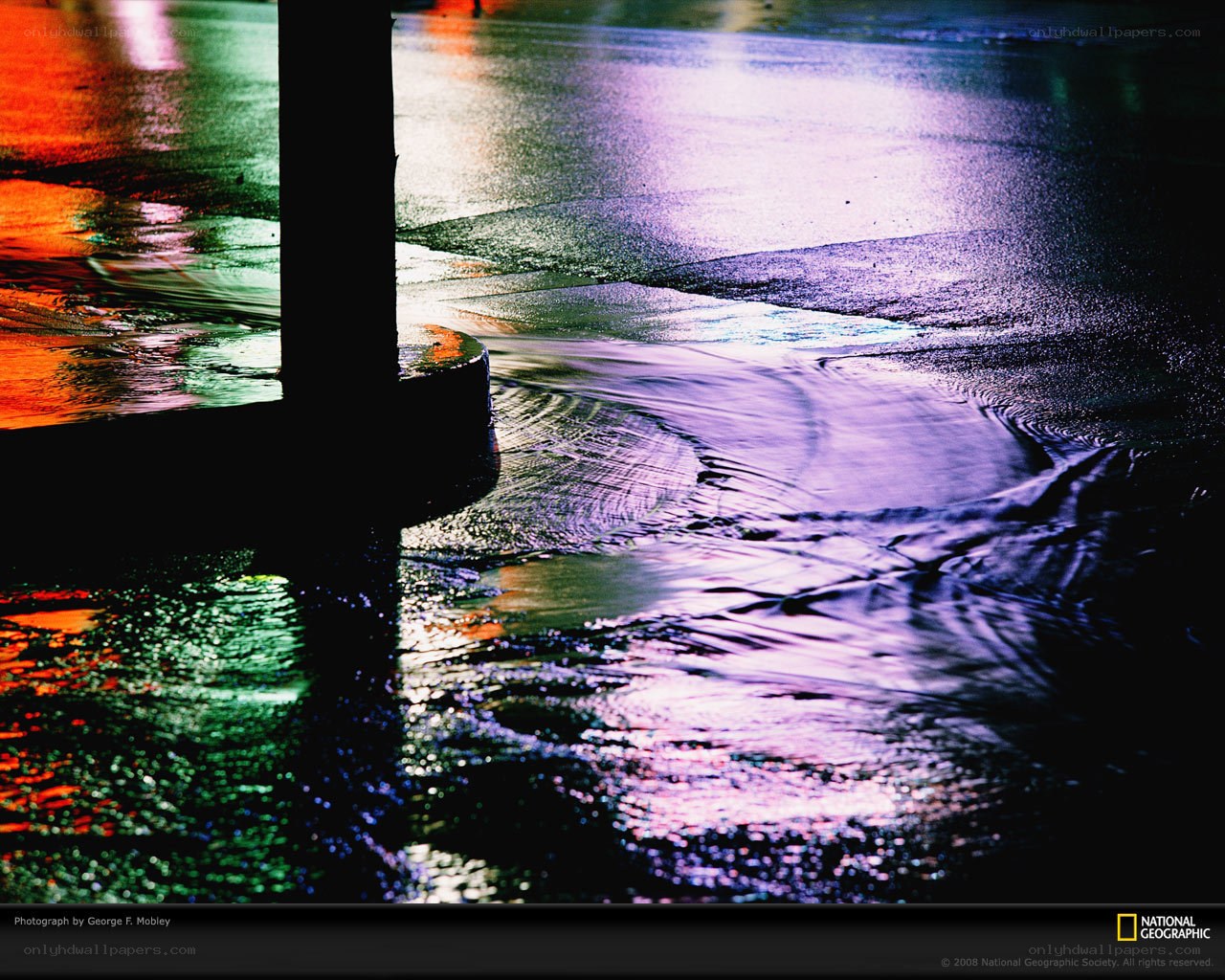 Colorful reflections on wet pavement