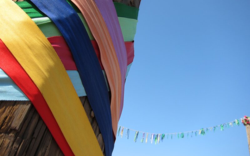 Colorful ribbons on a wooden post