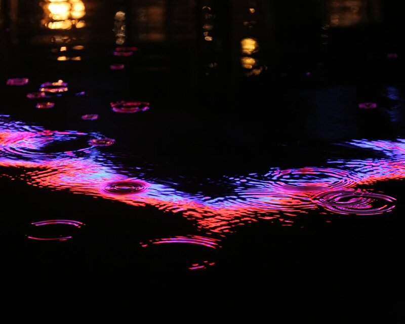colorful ripples on dark water