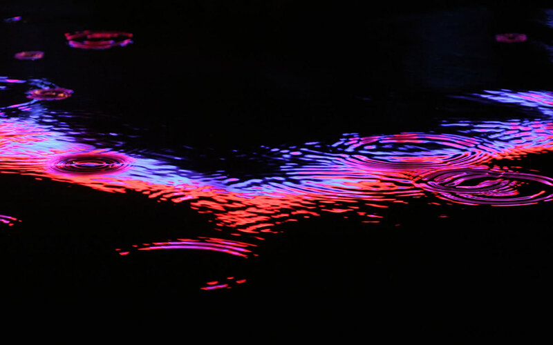 colorful ripples on dark water