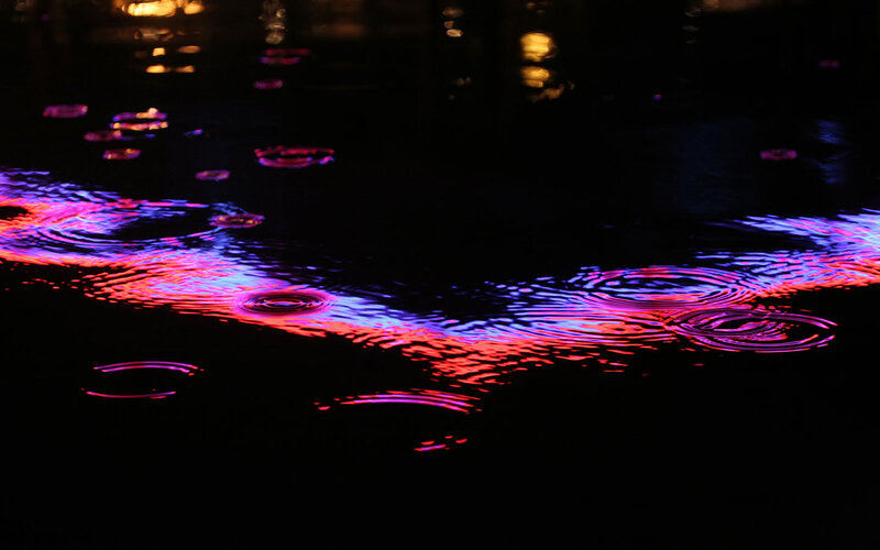 colorful ripples on dark water