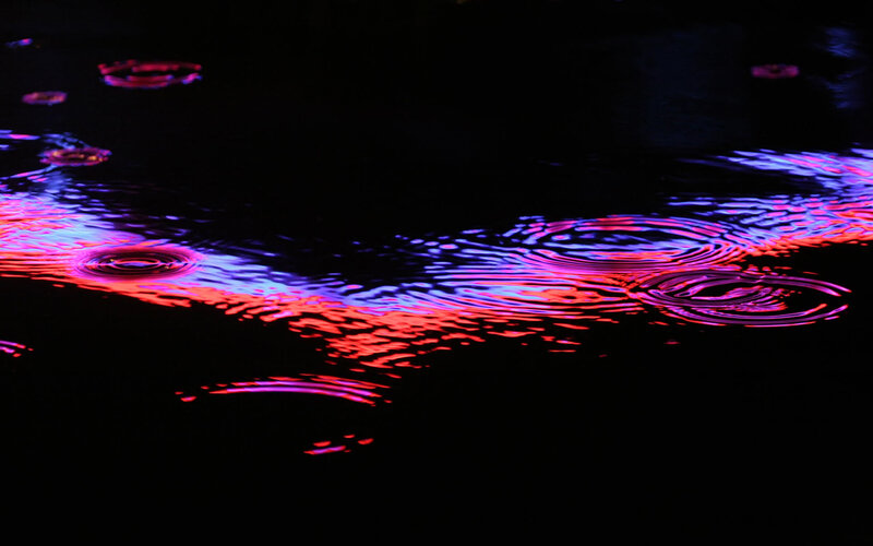 colorful ripples on dark water