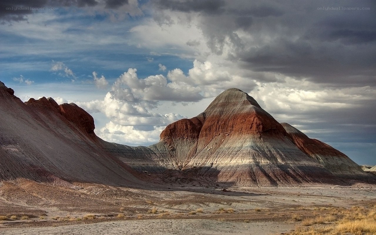 Colorful rock formations under cloudy sky