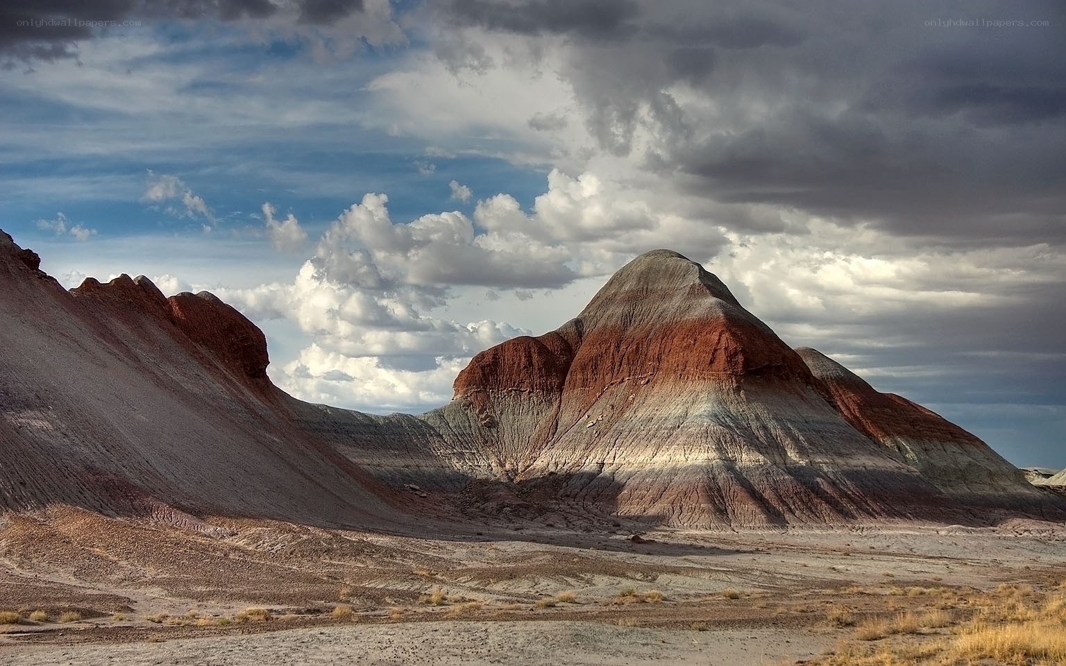 Colorful rock formations under cloudy sky