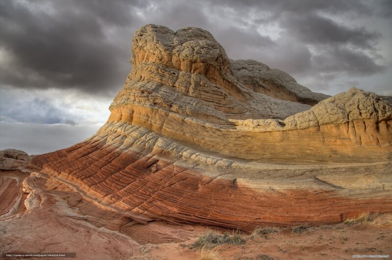 Colorful rock formations under stormy sky