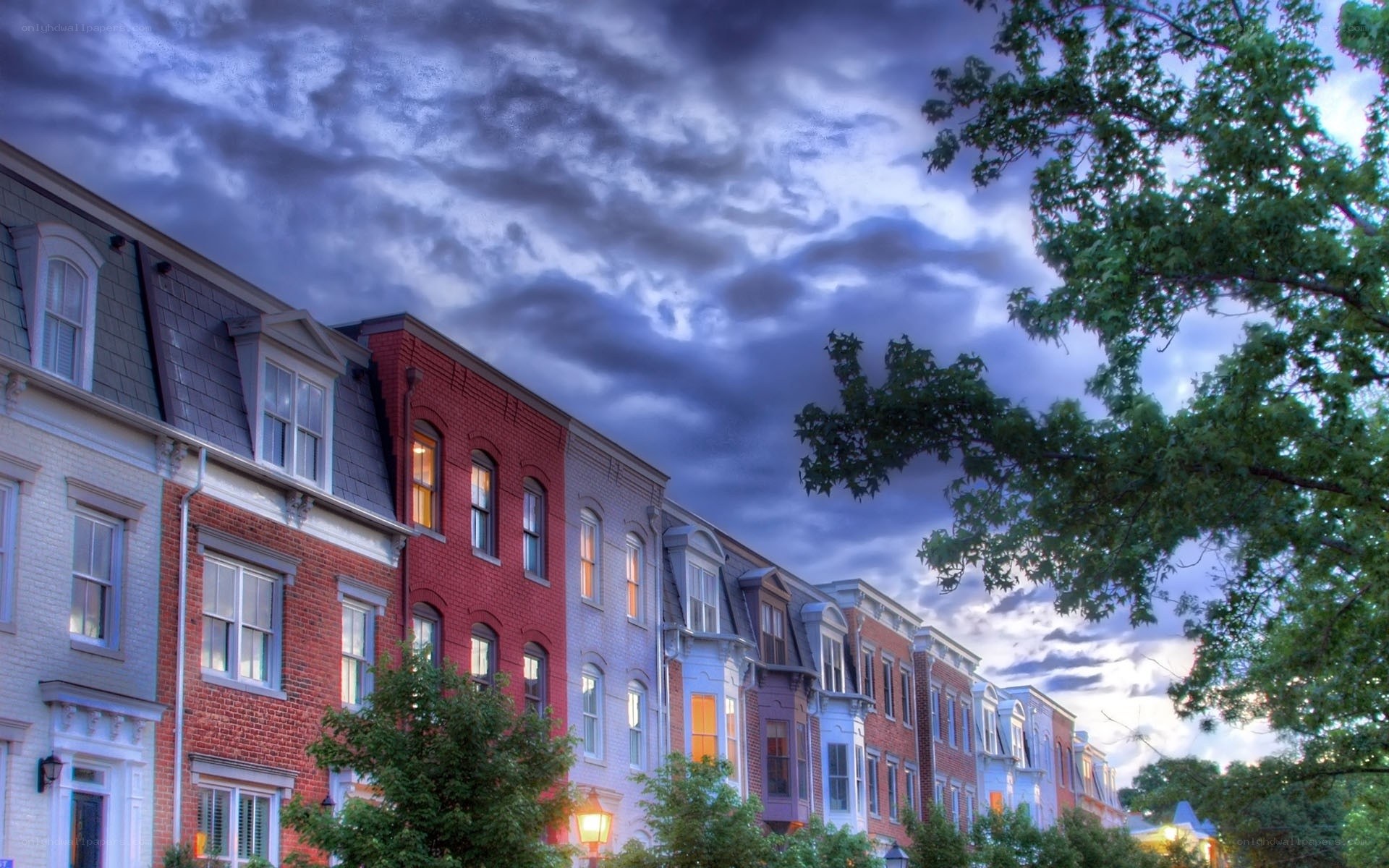 Colorful row houses under stormy sky