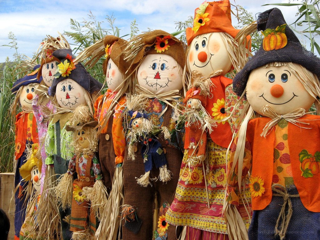 Colorful scarecrows in a field