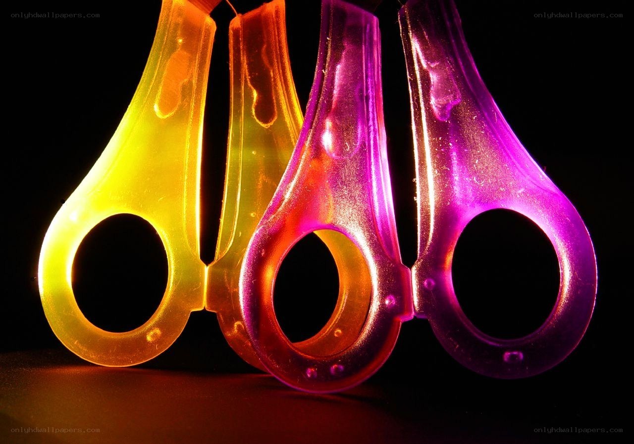 Colorful scissors in dark