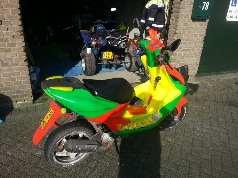 Colorful Scooter Outside Garage