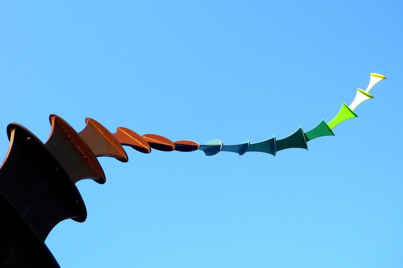 Colorful sculpture against blue sky