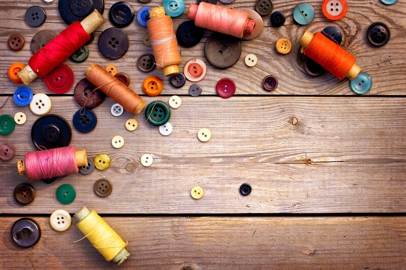 Colorful sewing supplies on wood