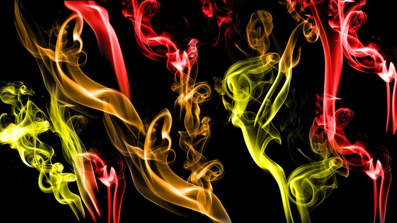 Colorful smoke swirls on black