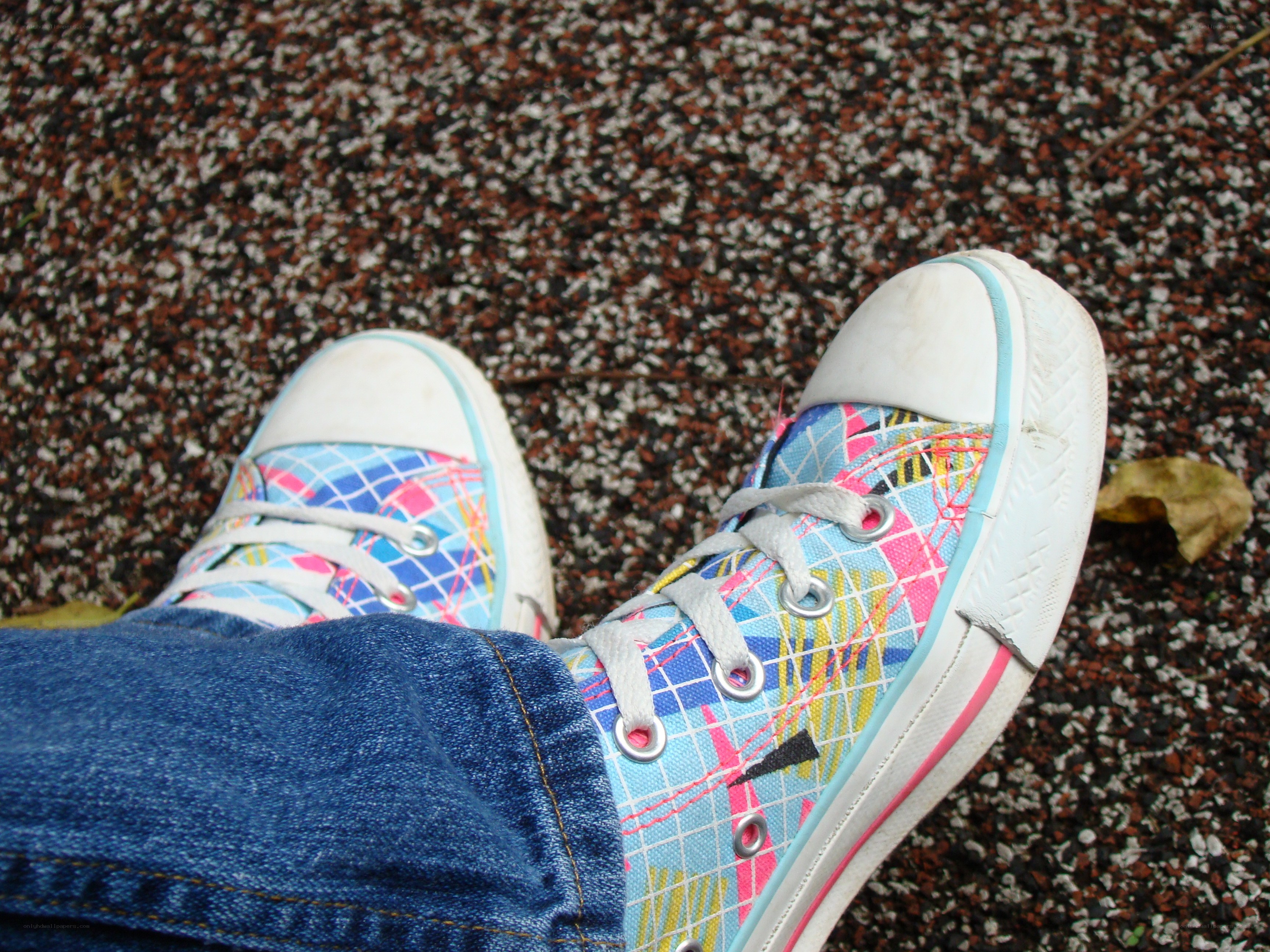 colorful sneakers on pavement