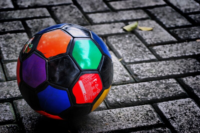 colorful soccer ball on pavement