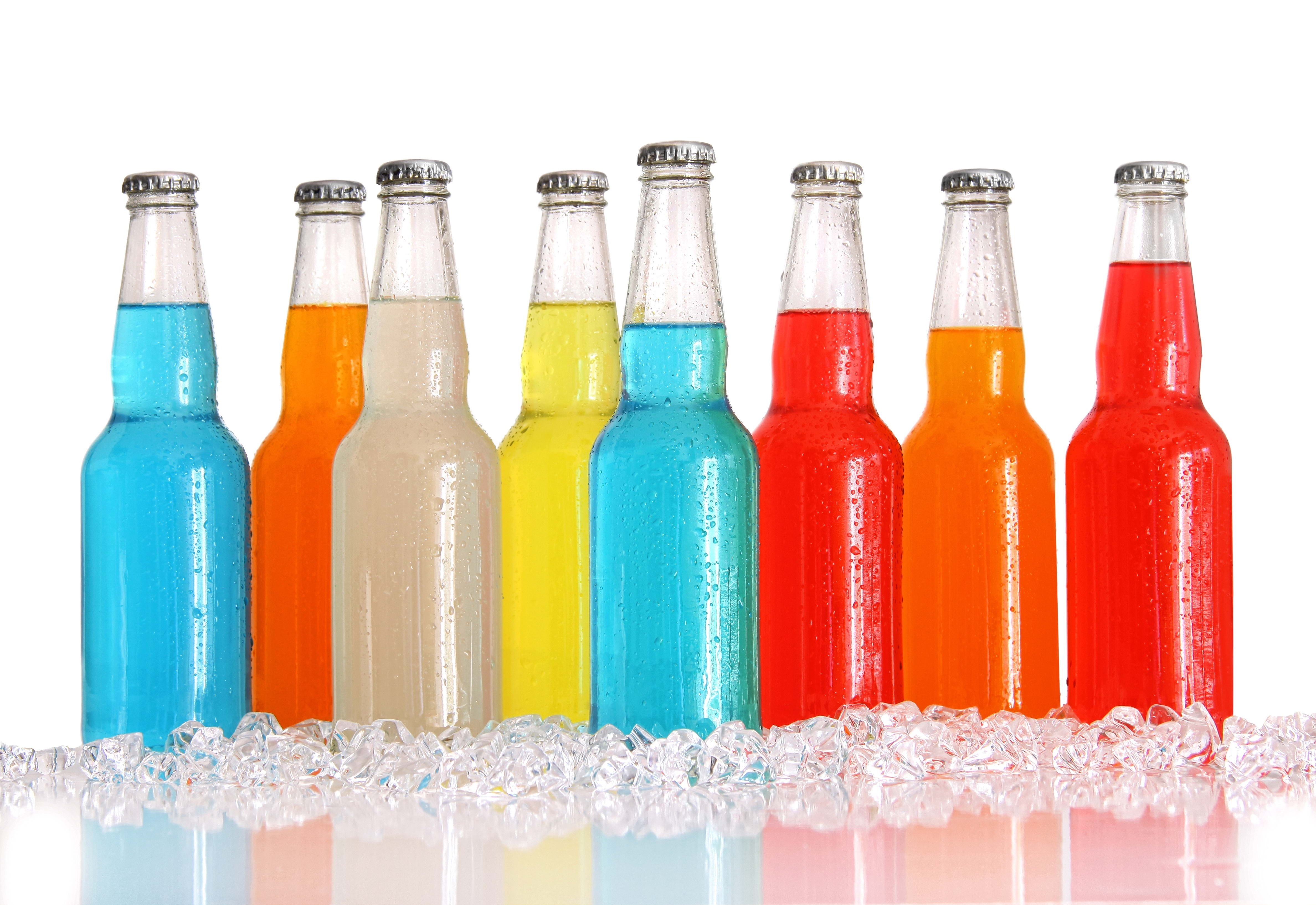 Colorful soda bottles on ice