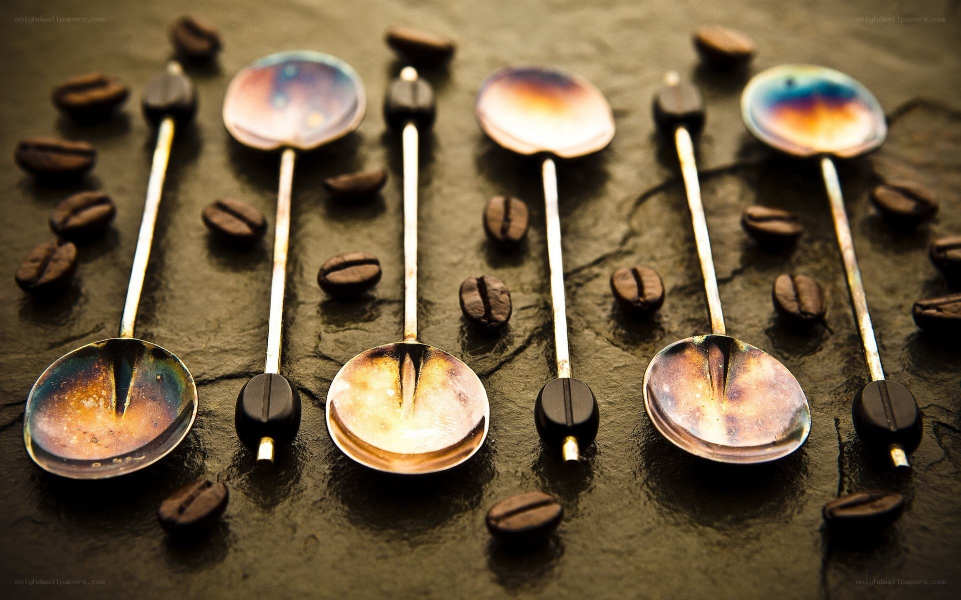Colorful spoons with coffee beans