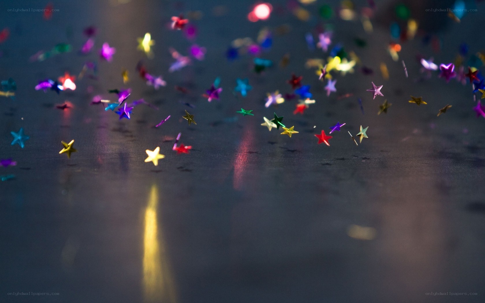 Colorful star confetti on dark surface