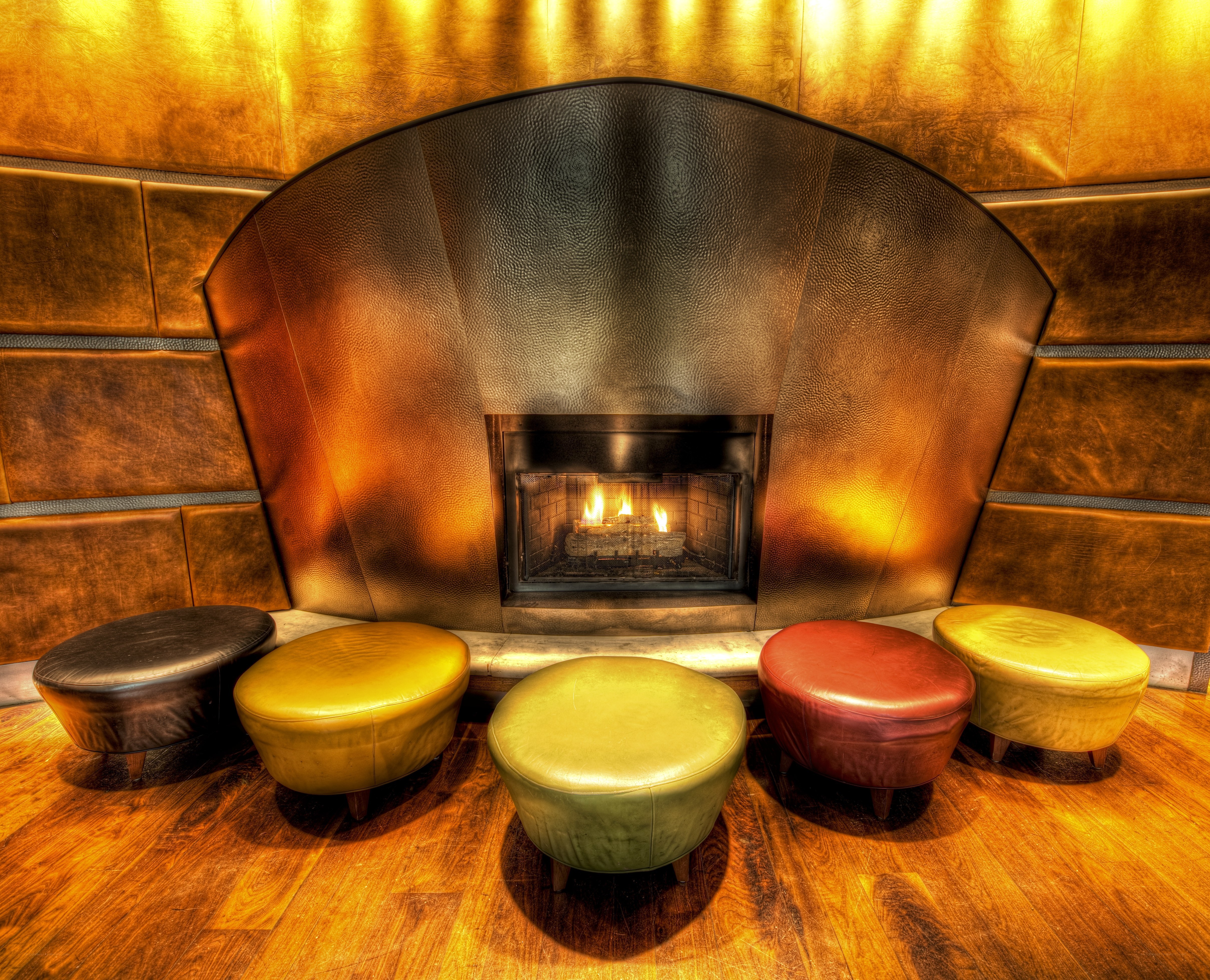 Colorful stools by a fireplace