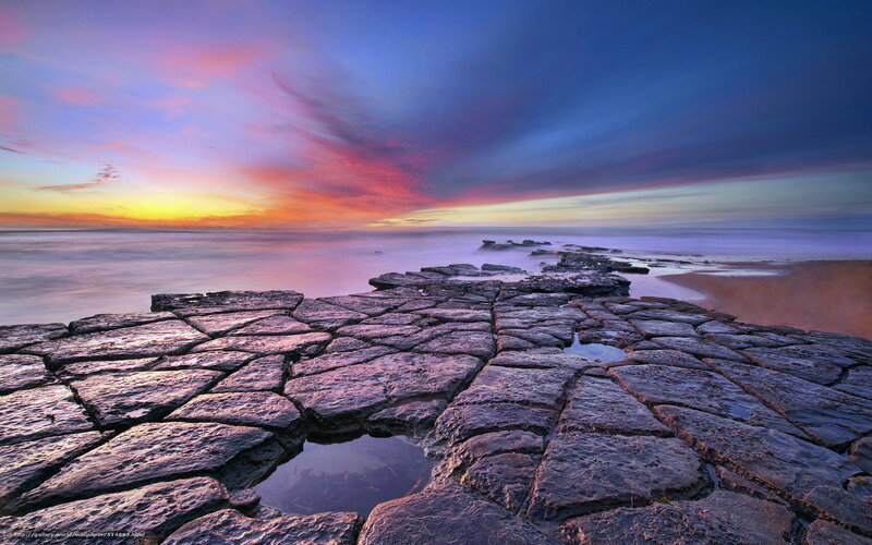 Colorful sunset over rocky shore