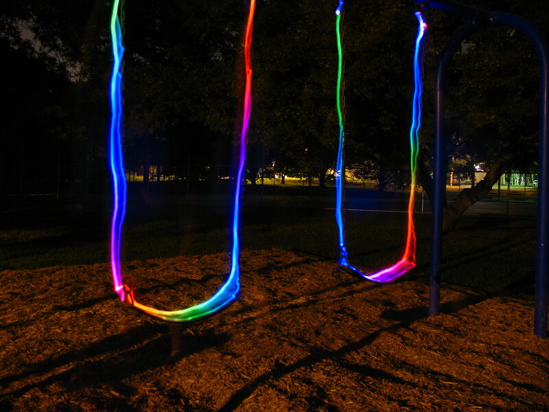 Colorful swings at night