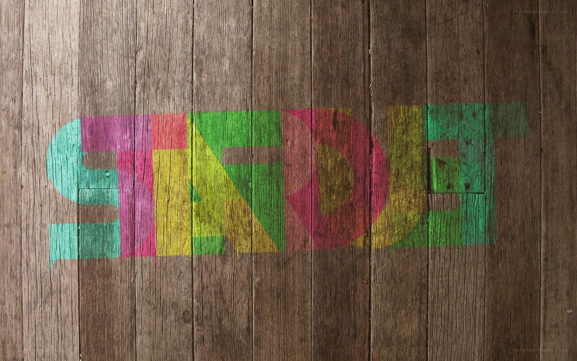colorful text on wooden wall