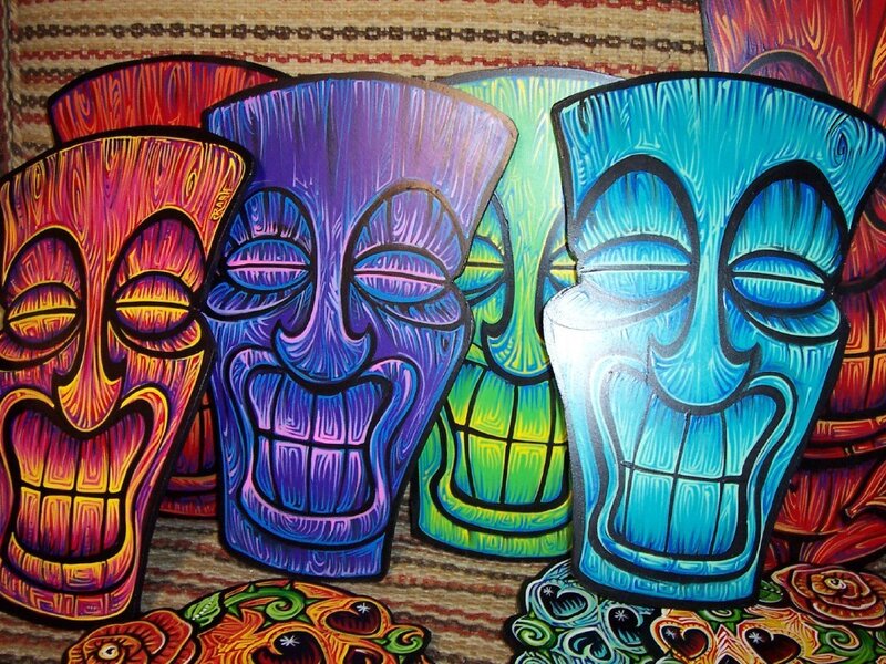 Colorful tiki masks on patterned fabric