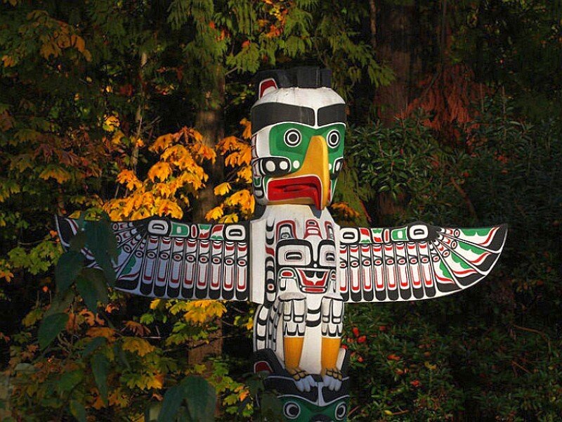 colorful totem pole in forest