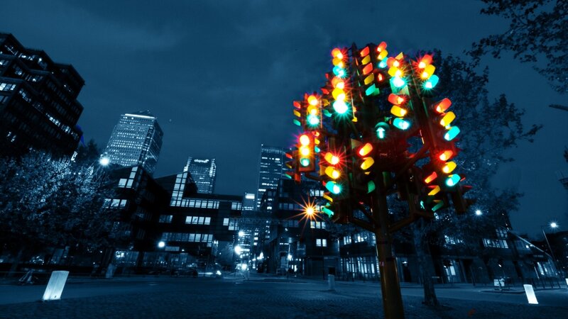Colorful traffic light sculpture at night