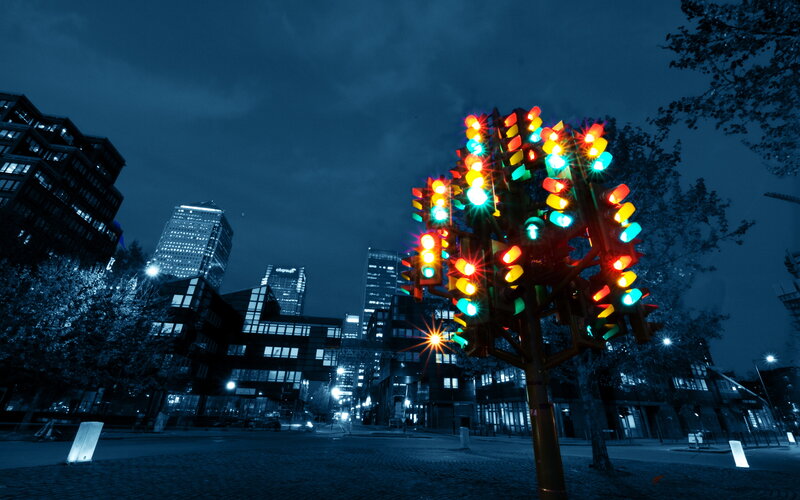 Colorful traffic light sculpture at night