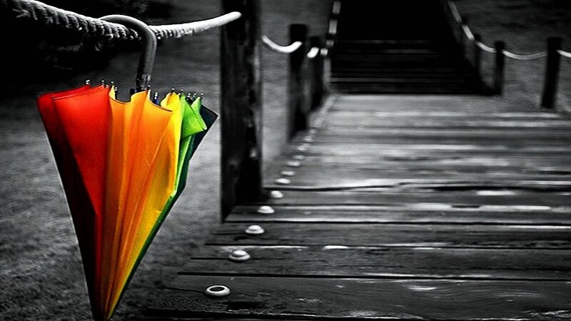 Colorful umbrella on a dock