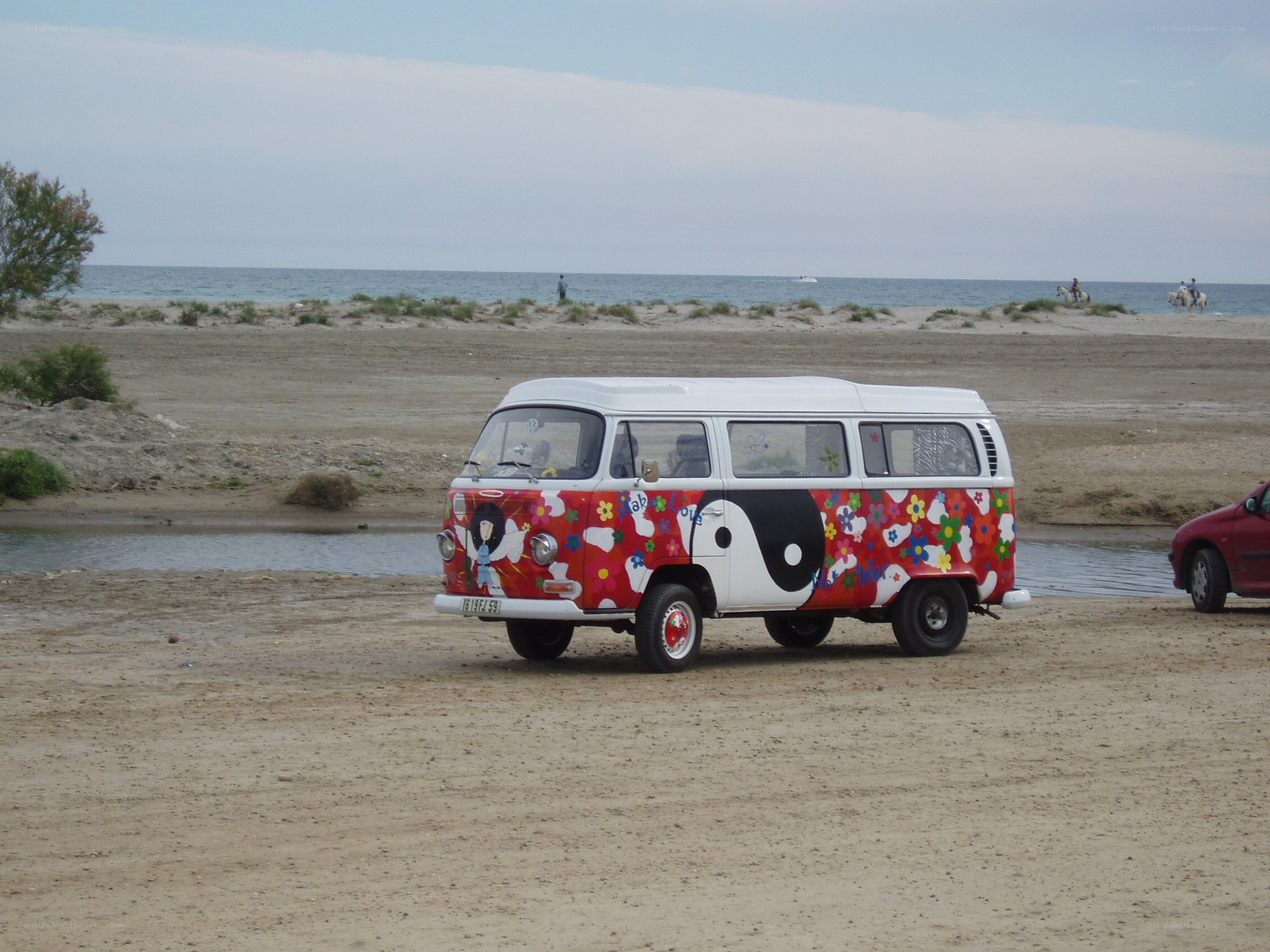 Colorful van on a sandy beach