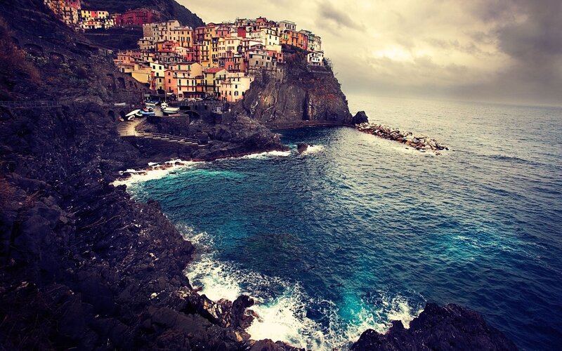 Colorful Village on Cliff — Blue, Dramatic, Afternoon, Photograph, Sea, Rocks