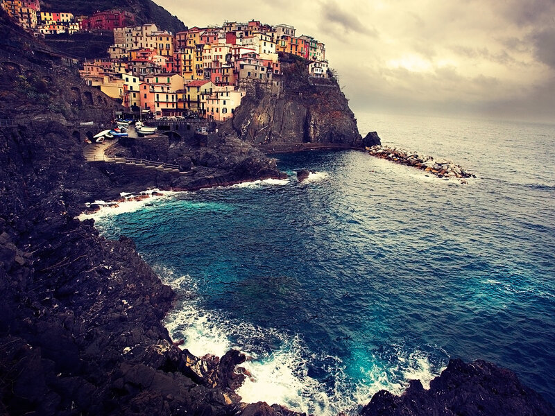 Colorful Village on Cliff — Blue, Dramatic, Afternoon, Photograph, Sea