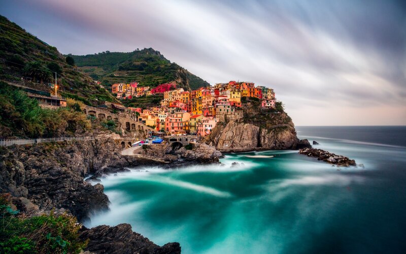 Colorful Village on Cliff — Blue, Dramatic, Sunset, Photograph, Sea