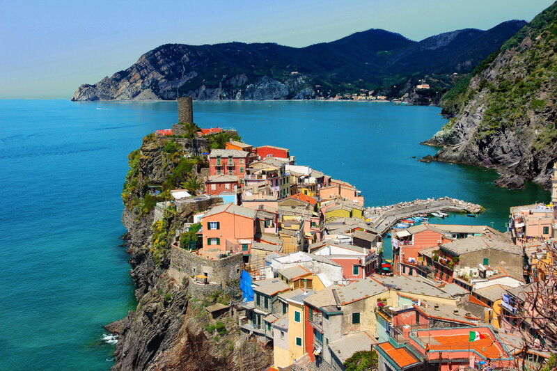 Colorful Village on Cliff — Blue, Serene, Afternoon, Photograph, Sea, Mountains, Buildings