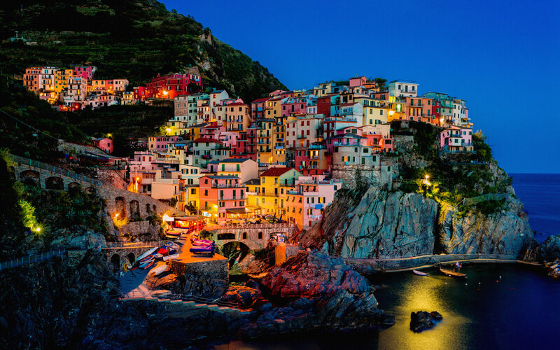 Colorful Village on Cliff — Blue, Serene, Night, Photograph, Sea, Mountain