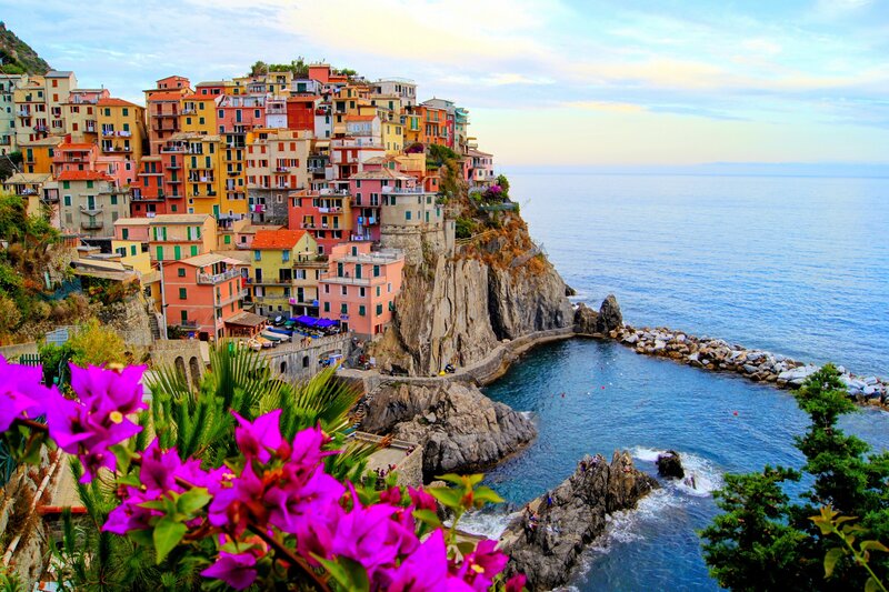 Colorful Village on Cliff — Blue, Serene, Sunset, Photograph, Sea, Flowers, Rocks, Buildings