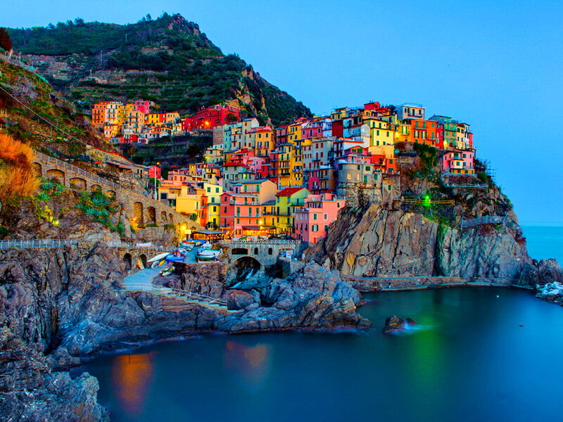 Colorful Village on Cliff — Blue, Serene, Sunset