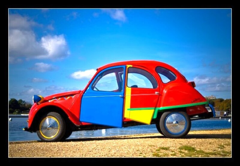 Colorful vintage car by the water
