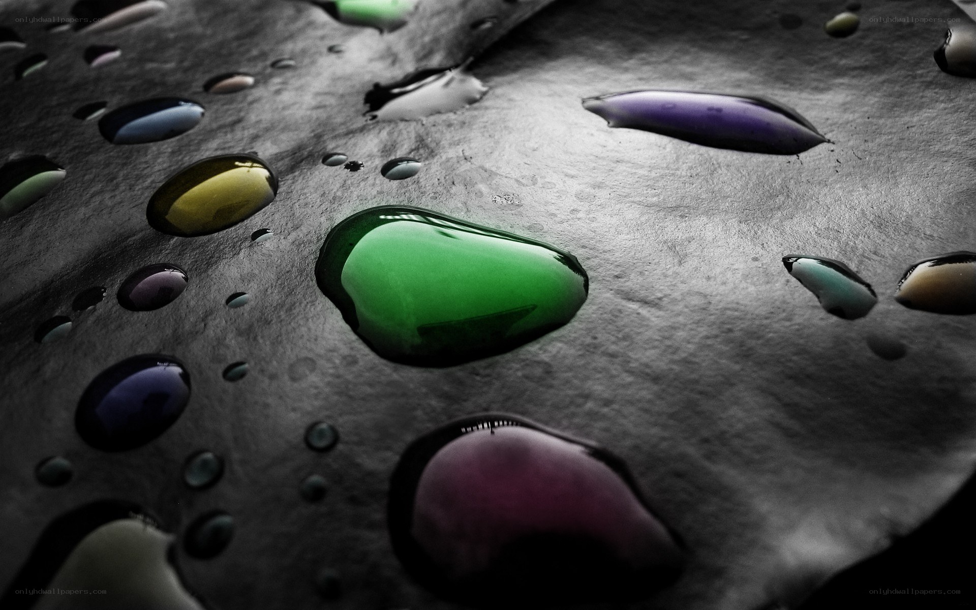Colorful water droplets on dark surface