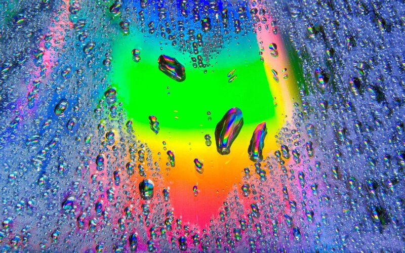 Colorful water droplets on glass